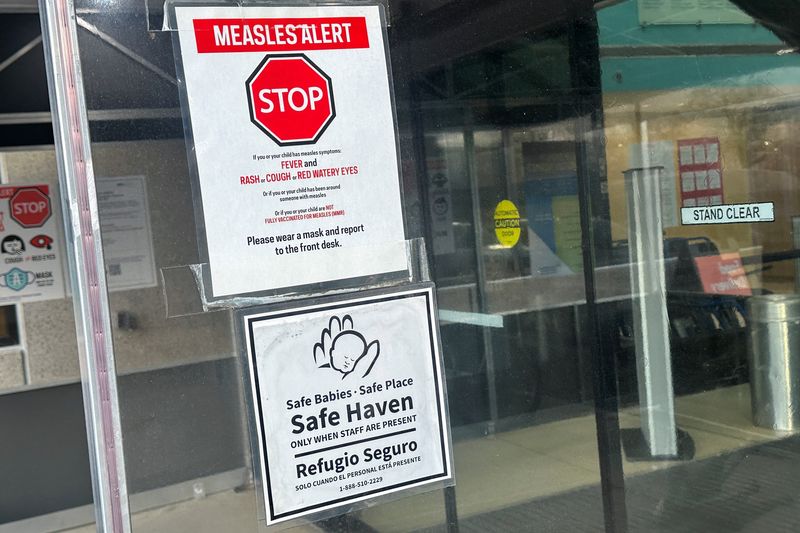 FILE PHOTO: A measles alert sign hangs outside the entrance to the Cohen Children's Medical Center, where the state health department confirmed that a baby tested positive and that there is a possibility of exposure to others at the facility, in New Hyde Park, New York, U.S., March 14, 2025. REUTERS/Shannon Stapleton
