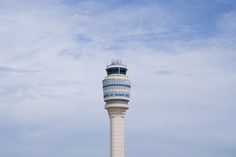 FILE PHOTO: The air traffic control tower is seen from the Hartsfield-Jackson Atlanta International Airport terminal, in Atlanta, Georgia, U.S. May 15, 2025.  REUTERS/Megan Varner/File photo