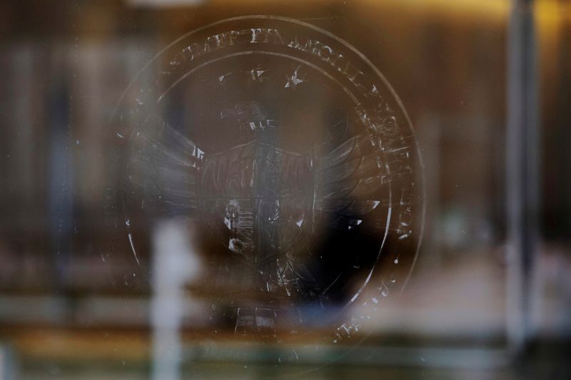 FILE PHOTO: The name and logo for the Consumer Financial Protection Bureau (CPFB) is seen scraped off the door of its building in Washington, D.C., U.S., February 20, 2025. REUTERS/Brian Snyder/File Photo