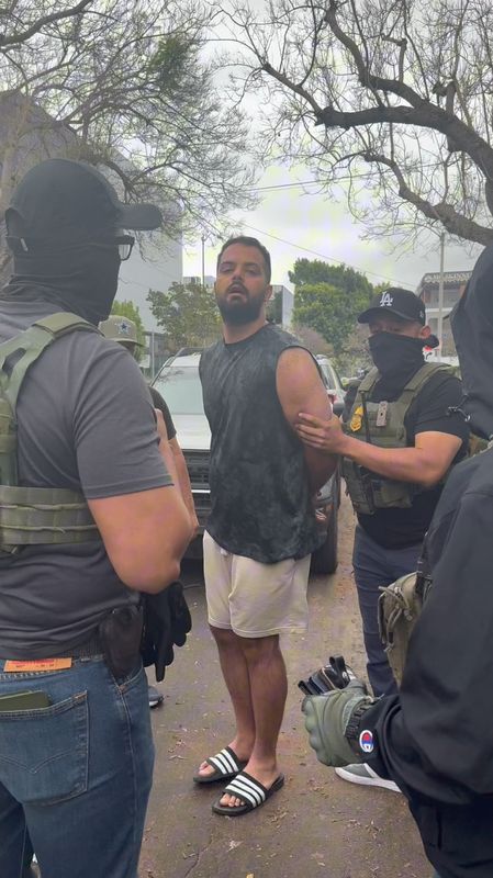 FILE PHOTO: Federal law enforcement officers detain an Iranian man in Los Angeles, California, U.S., June 24, 2025 in this screengrab taken from a social media video. Ara Torosian/via REUTERS/File Photo