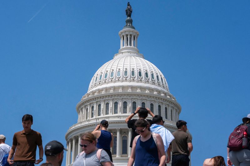FILE PHOTO: Visitors to the U.S. Capitol walk on Capitol Hill in Washington, D.C., U.S., June 25, 2025. REUTERS/Nathan Howard/File Photo