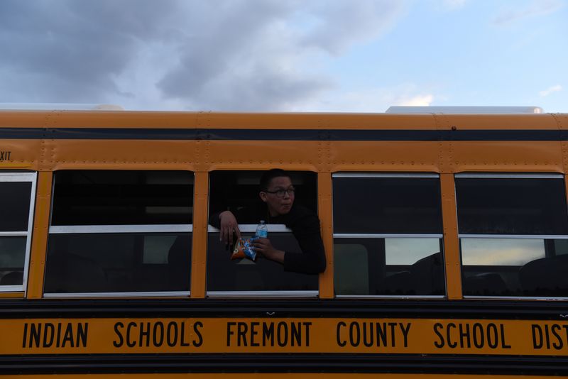 FILE PHOTO: A boy leans out of the window of a school bus in the tribal area on the grounds of the Fort Laramie National Historic Site in Fort Laramie, Wyoming, U.S., April 28, 2018. REUTERS/Stephanie Keith/File Photo