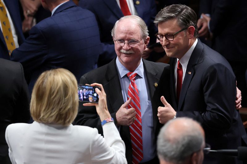 U.S. House of Representatives Speaker Mike Johnson poses for a picture with U.S. Representative John Rutherford (R-FL) on the day of a vote in the U.S. House of Representatives on final passage of U.S. President Donald Trump's sweeping spending and tax bill, on Capitol Hill in Washington, D.C., U.S., July 3, 2025. REUTERS/Jonathan Ernst