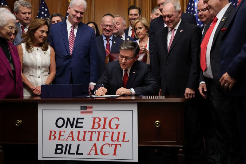 U.S. House of Representatives Speaker Mike Johnson signs the U.S. President Donald Trump's sweeping spending and tax bill, on Capitol Hill in Washington, D.C., U.S., July 3, 2025. REUTERS/Jonathan Ernst