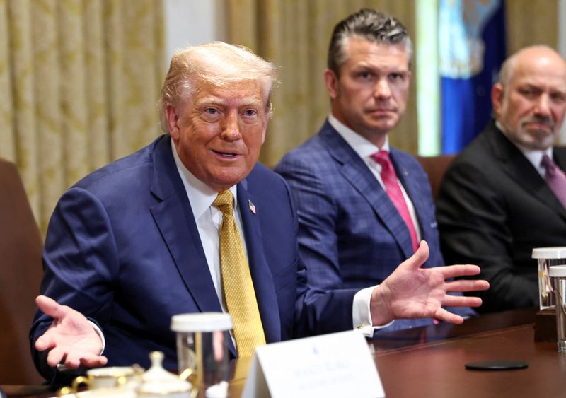 U.S. President Donald Trump speaks next to Defense Secretary Pete Hegseth and Secretary of Commerce Howard Lutnick during a cabinet meeting at the White House in Washington, D.C., U.S., July 8, 2025.   REUTERS/Kevin Lamarque