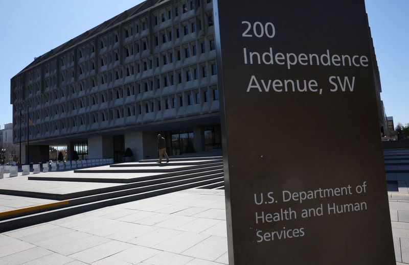A person walks outside of the U.S. Department of Health and Human Services building after it was reported that the HHS will cut about 10,000 full-time jobs and close half of its regional offices, a major overhaul of the department under Health Secretary Robert F. Kennedy Jr., in Washington, D.C., U.S., March 27, 2025. REUTERS/Leah Millis