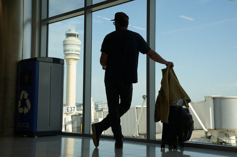 FILE PHOTO: The air traffic control tower can be seen from the Hartsfield Jackson Atlanta International Airport terminal, in Atlanta, Georgia, U.S. May 15, 2025.  REUTERS/Megan Varner/File Photo