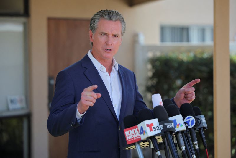 FILE PHOTO: California Governor Gavin Newsom speaks during a press conference after the federal government's demobilization of 2,000 National Guard members, in Downey, California, U.S. July 16, 2025. REUTERS/Daniel Cole/File Photo