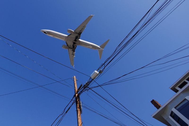 FILE PHOTO: A commercial aircraft approaches to land at San Diego International Airport in San Diego, California, U.S., January 6, 2022. REUTERS/Mike Blake/File Photo