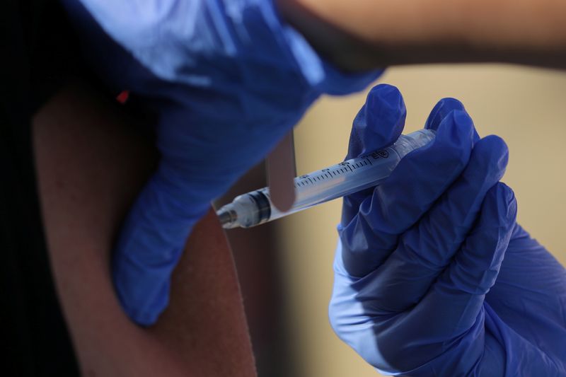 FILE PHOTO: A woman is flu vaccinated in San Diego, California, U.S., October 9, 2017. REUTERS/Mike Blake/File Photo