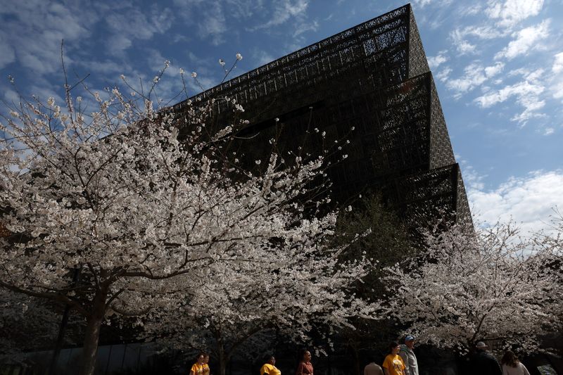 FILE PHOTO: People walk past the Smithsonian’s National Museum of African American History and Culture in Washington, D.C., U.S., March 28, 2025. REUTERS/Leah Millis/ File Photo