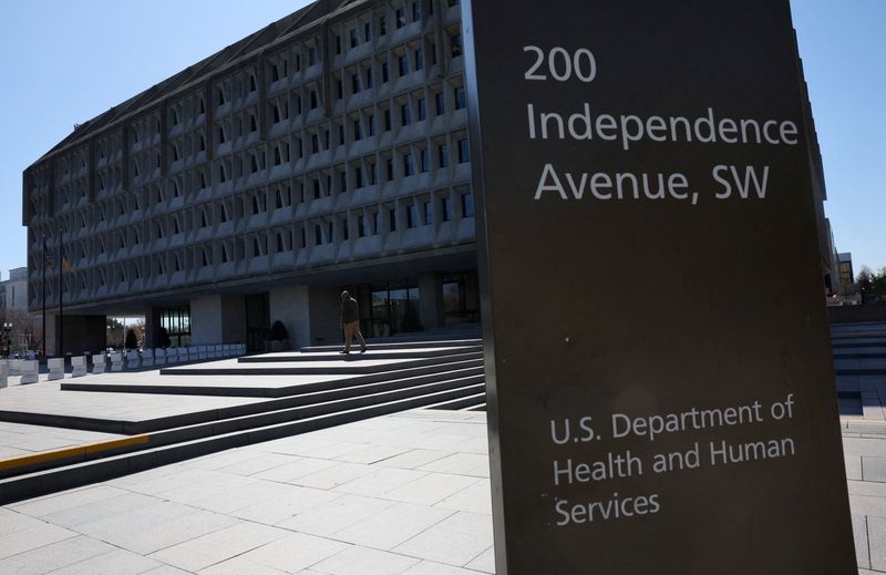 FILE PHOTO: A person walks outside of the U.S. Department of Health and Human Services building in Washington, D.C., U.S., March 27, 2025. REUTERS/Leah Millis/File Photo