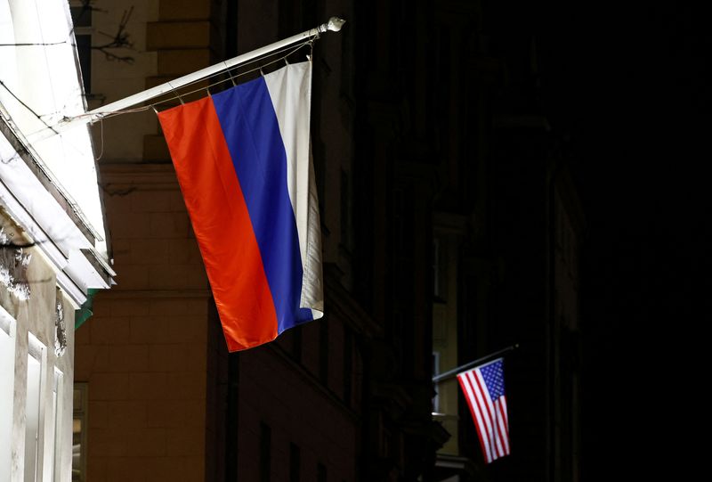 FILE PHOTO: A view shows the Russian flag on the facade of a historic building alongside the American flag on the facade of the U.S. Embassy in Moscow, Russia March 18, 2025. REUTERS/Yulia Morozova/File photo