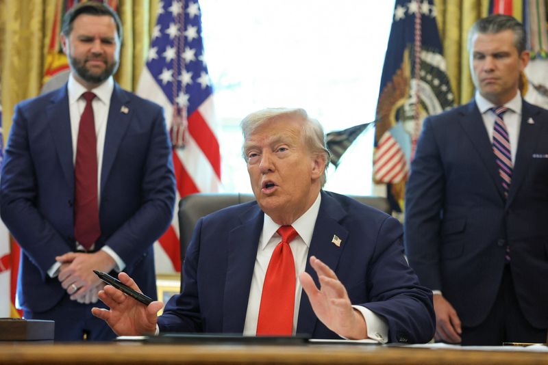U.S. President Donald Trump speaks after signing an executive order, as U.S. Vice President JD Vance and U.S. Defense Secretary Pete Hegseth look on, in the Oval Office at the White House in Washington, D.C., U.S., August 25, 2025. REUTERS/Jonathan Ernst