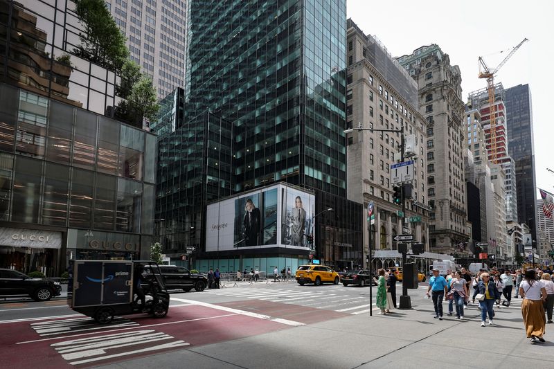 FILE PHOTO: Pedestrians walk past a retail space at 715-717 Fifth Avenue in New York City, U.S., May 27, 2025. REUTERS/Jeenah Moon/File Photo