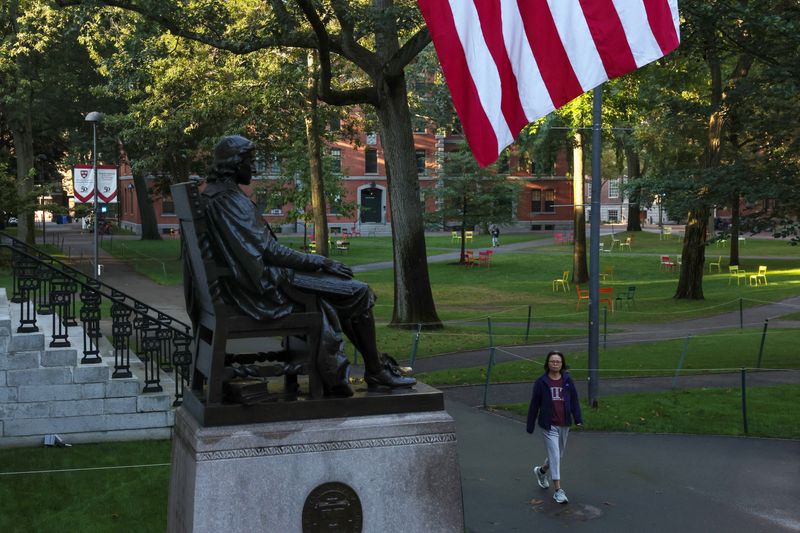 A woman walks on campus at Harvard University in Cambridge, Massachusetts, U.S., September 4, 2025. REUTERS/Shannon Stapleton