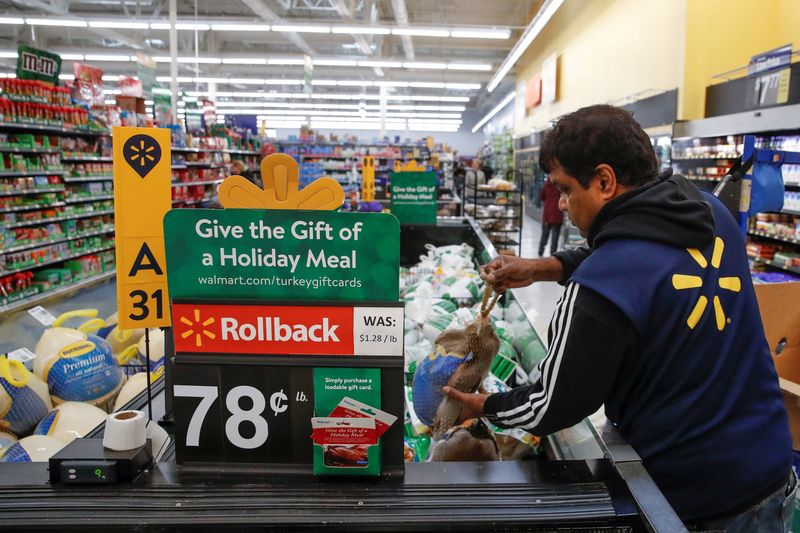 FILE PHOTO: A Walmart employee puts out a frozen turkey ahead of the Thanksgiving holiday in Chicago, Illinois, U.S. November 27, 2019. REUTERS/Kamil Krzaczynski/File Photo