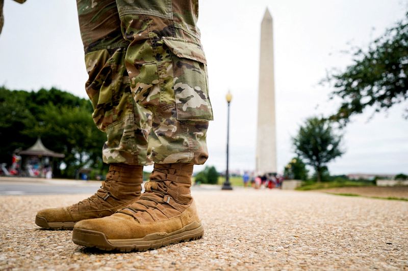FILE PHOTO: A member of the Mississippi National Guard stands near the Washington Monument on the National Mall after U.S. President Donald Trump deployed the National Guard and ordered an increased presence of federal law enforcement to assist in crime prevention, in Washington, D.C., U.S., August 21, 2025. REUTERS/Al Drago/File Photo