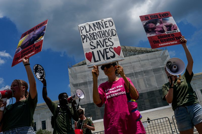 Pro-planned parenthood and pro-abortion activists demonstrate outside the U.S. Supreme Court in Washington, D.C., U.S., June 26, 2025. REUTERS/Elizabeth Frantz