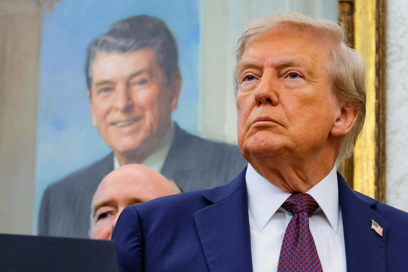 FILE PHOTO: U.S. President Donald Trump, in front of a painting of former U.S. President Ronald reagan, attends an event to announce that the Space Force Command will move from Colorado to Alabama, in the Oval Office at the White House in Washington, D.C., U.S., September 2, 2025. REUTERS/Brian Snyder/File Photo