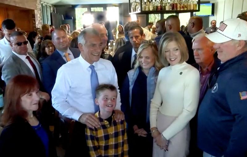New Jersey Republican candidate for Governor, Jack Ciattarelli, poses with a child during a campaign event in Red Bank, New Jersey, U.S., October 22, 2025, in this screengrab taken from video. Reuters TV via REUTERS