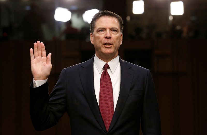 FILE PHOTO: Former FBI Director James Comey is sworn in prior to testifying before a Senate Intelligence Committee hearing on Russia's alleged interference in the 2016 U.S. presidential election on Capitol Hill in Washington, U.S., June 8, 2017. REUTERS/Jonathan Ernst/File Photo