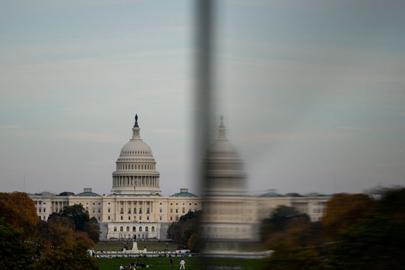 The dome of the U.S. Capitol is reflected in a window as people visit the Washington Monument, more than a month into the continuing U.S. government shutdown in Washington, D.C., U.S., November 2, 2025. REUTERS/Kent Nishimura
