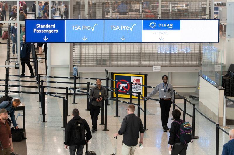 Travellers make their way to a Transportation Security Administration (TSA) security checkpoint in the Minneapolis–Saint Paul International Airport during the government shutdown, in Minneapolis, U.S., October 29, 2025.  REUTERS/Tim Evans