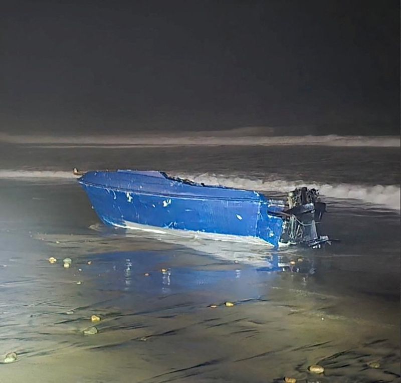 A vessel which capsized off the coast, prompting a search for its missing occupants, lies on a beach in Imperial Beach, California, U.S., November 14, 2025.  U.S. Coast Guard/Handout via REUTERS