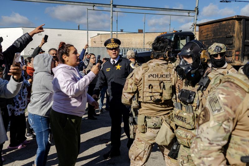 FILE PHOTO: Federal agents confront community members during a standoff, after U.S. President Donald Trump ordered increased federal law enforcement presence to assist in crime prevention, in Chicago, Illinois, U.S., October 23, 2025. REUTERS/Jim Vondruska/File Photo