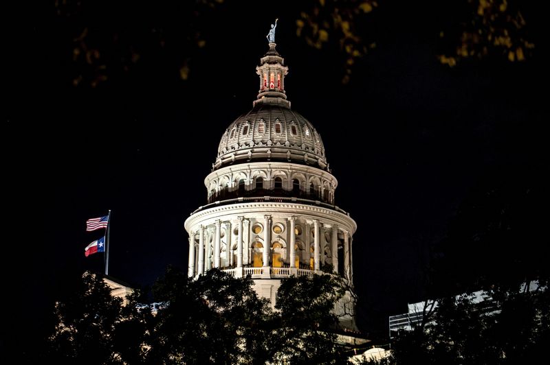 FILE PHOTO: The Texas Capitol is lit during a session in the State Senate, as Republicans attempt to pass an HB 4, a bill that would redraw the state's 38 Congressional Districts, in Austin, Texas, U.S. August 22, 2025. REUTERS/Sergio Flores/File Photo