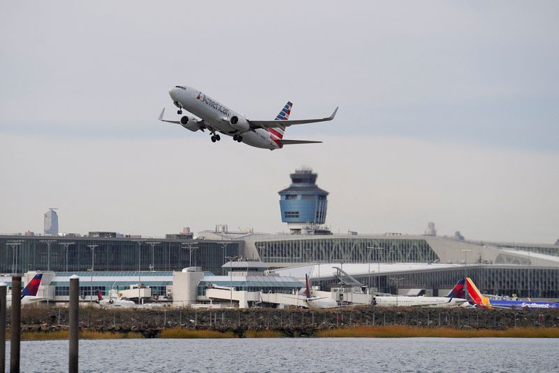 FILE PHOTO: An American Airlines airplane takes off from New York's Laguardia Airport after the FAA ordered flight cuts at 40 major airports amid the ongoing U.S. government shutdown in the Queens borough of New York City, U.S., November 7, 2025. REUTERS/Ryan Murphy/File Photo
