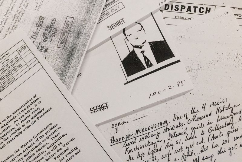 FILE PHOTO: Documents related to the 1963 assassination of President John F. Kennedy are displayed after they were released following an order from U.S. President Donald Trump, in Washington D.C., March 18, 2025. REUTERS/Carlos Barria/Photo illustration/File Photo