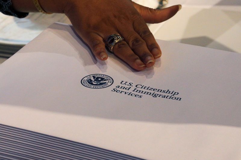 Information packs are distributed by the U.S. Citizenship and Immigration Services following a citizenship ceremony at the John F. Kennedy Presidential Library in Boston, Massachusetts, U.S., July 18, 2018.   REUTERS/Brian Snyder