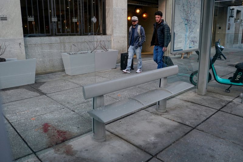 Pedestrians walk past the scene where two National Guard members were shot yesterday in Washington, D.C., U.S., November 27, 2025. REUTERS/Nathan Howard      TPX IMAGES OF THE DAY