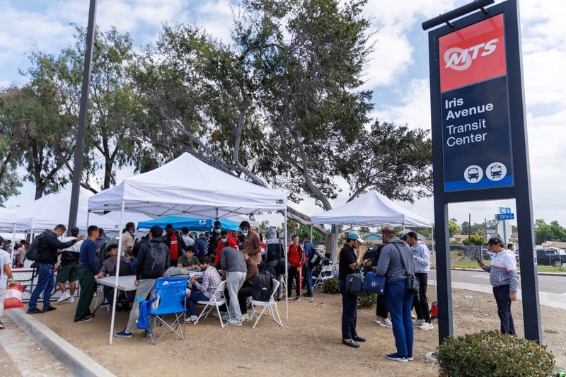Migrants, who crossed the U.S.-Mexico border and were detained and released by U.S. Customs and Border Protection, gather at a transit station as they plan to travel across the country from the San Ysidro neighborhood of San Diego, California, U.S., September 20, 2023. REUTERS/Mike Blake