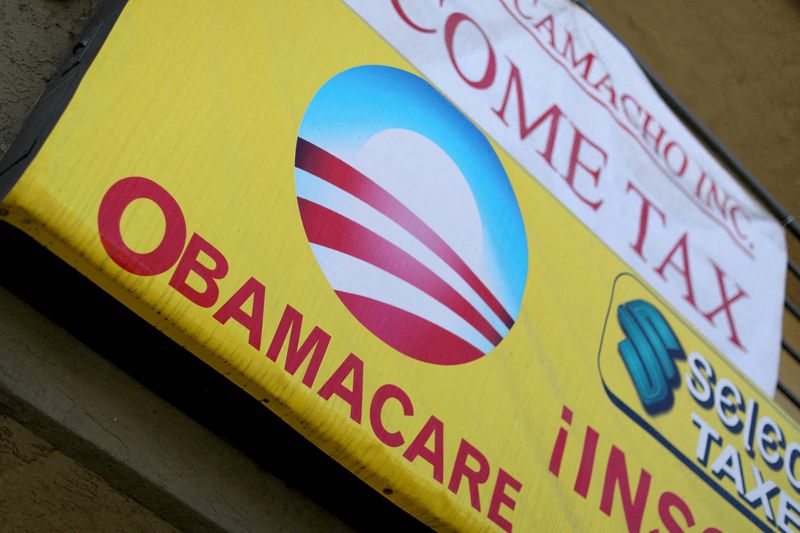FILE PHOTO: A sign on an insurance store advertises Obamacare in San Ysidro, San Diego, California, U.S., October 26, 2017. REUTERS/Mike Blake/File Photo