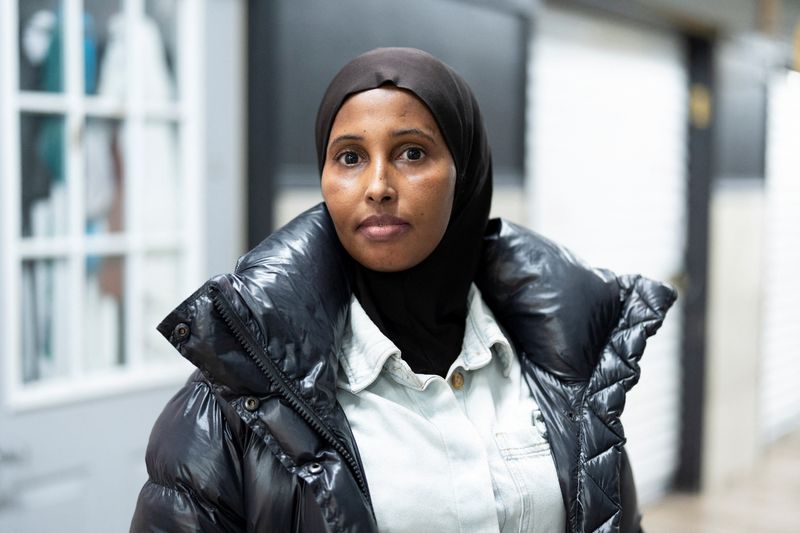 Salon owner and Somali immigrant Ifrah Farah stands for a portrait outside her business at Karmel Mall, an East African shopping center that has seen its number of visitors drop amid fears of a reported federal operation targeting Somali immigrants, in Minneapolis, Minnesota, U.S. December 3, 2025. REUTERS/Tim Evans