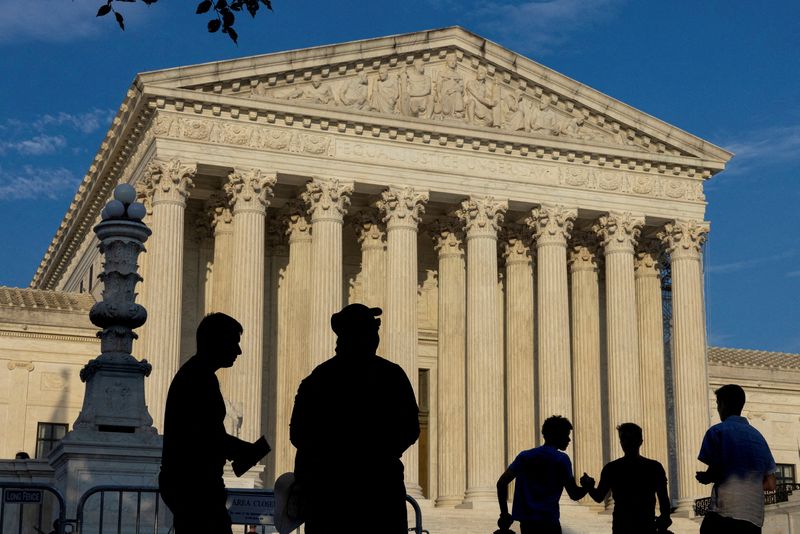 FILE PHOTO: People gather outside the U.S. Supreme Court in Washington, U.S., June 29, 2024. REUTERS/Kevin Mohatt/File Photo