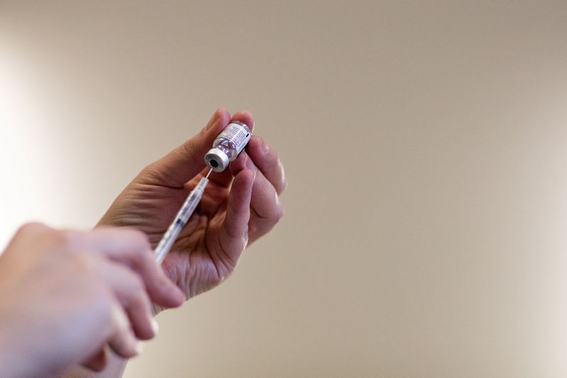 A nurse fills up syringes with the coronavirus disease (COVID-19) vaccines for residents who are over 50 years old and immunocompromised and are eligible to receive their second booster shots in Waterford, Michigan, U.S., April 8, 2022.  REUTERS/Emily Elconin