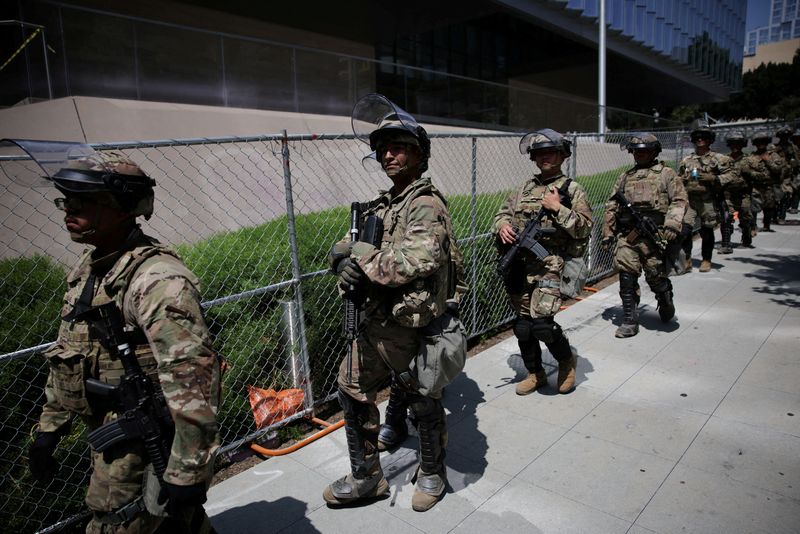 FILE PHOTO: Members of the National Guard walk in formation as demonstrators take part in the No Kings protest against U.S. President Donald Trump's policies, in Los Angeles, California, U.S., June 14, 2025.  REUTERS/Daniel Cole/ File Photo