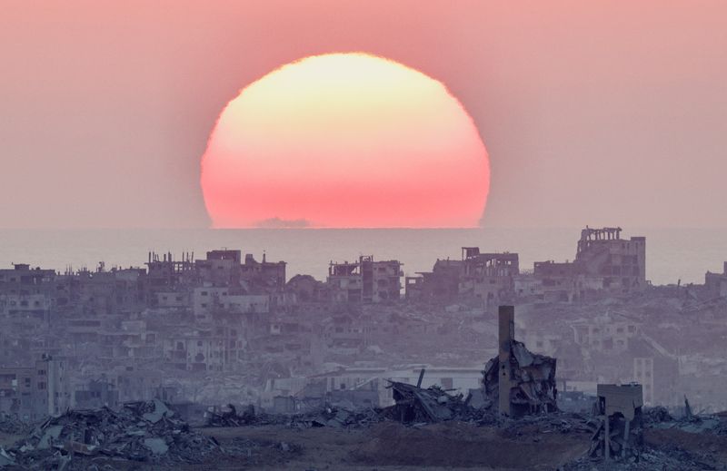 The sun sets over north Gaza, as seen from the Israeli side of the border, July 28, 2025. REUTERS/Amir Cohen