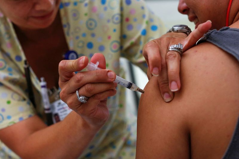 FILE PHOTO: A teenager receives a tetanus vaccination at the Remote Area Medical and Operation Lone Star joint health clinic at Palmview High School in Mission, Texas August 5, 2014. REUTERS/Shannon Stapleton/File Photo