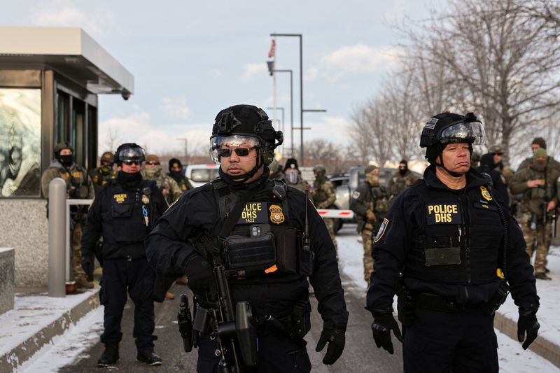 Federal Protective Service (FPS) agents stand guard outside the Bishop Henry Whipple Federal Building during a protest against increased immigration enforcement, days after a U.S. Immigration and Customs Enforcement (ICE) agent fatally shot Renee Nicole Good, in Minneapolis, Minnesota, U.S., January 10, 2026. REUTERS/Tyrone Siu