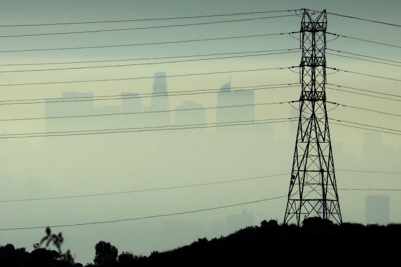 Downtown Los Angeles is seen behind an electricity pylon through the morning marine layer in Los Angeles, California, U.S., August 20, 2019. REUTERS/Lucy Nicholson