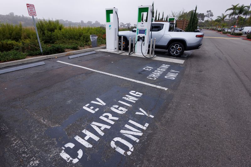 Electric vehicle chargers from Electrify America are shown in a shopping center parking lot in Oceanside, California, U.S.,October 19, 2023.     REUTERS/Mike Blake