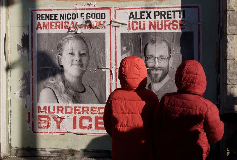 Children look at posters honoring Alex Pretti and Renee Nicole Good, who were fatally shot by federal immigration agents in separate incidents on January 24 and January 7, respectively, near the site of Pretti’s death, in Minneapolis, Minnesota, U.S., January 31, 2026. REUTERS/Tim Evans