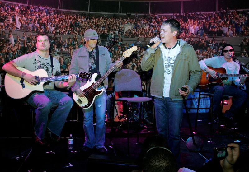 FILE PHOTO: Members of the band "3 Doors Down" perform during the 2007 International Consumer Electronics Show (CES) in Las Vegas, Nevada January 9, 2007. Band members are (from L-R) guitarist Chris Henderson, bassist Todd Harnell, vocalist Brad Arnold, and guitarist Matt Roberts.  REUTERS/Steve Marcus/File Photo