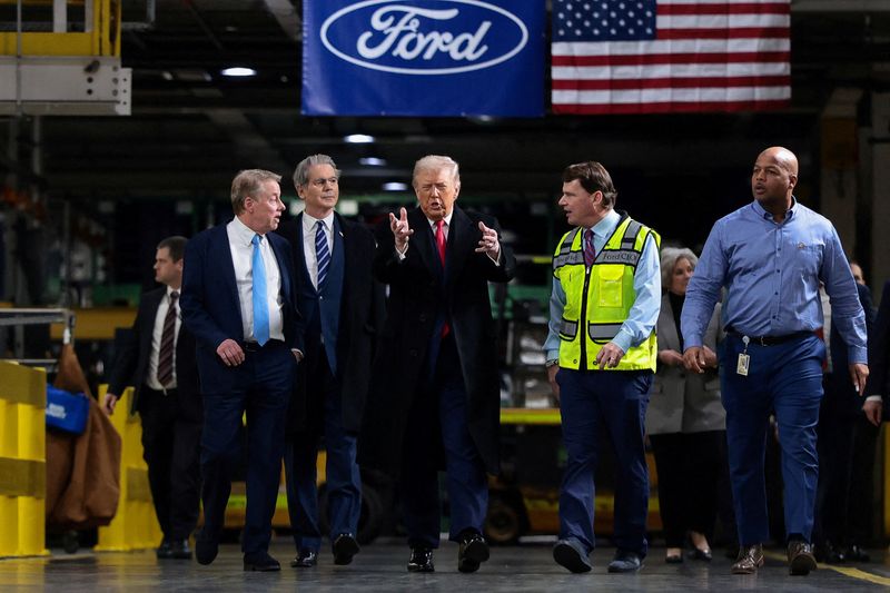 FILE PHOTO: U.S. President Donald Trump walks with Treasury Secretary Scott Bessent, Bill Ford, Executive Chairman of Ford, Jim Farley, CEO of Ford and Corey Williams, Ford River Rouge Plant Manager, during President Trump's visit to a Ford production center in Dearborn, Michigan, U.S., January 13, 2026. REUTERS/Evelyn Hockstein/File Photo