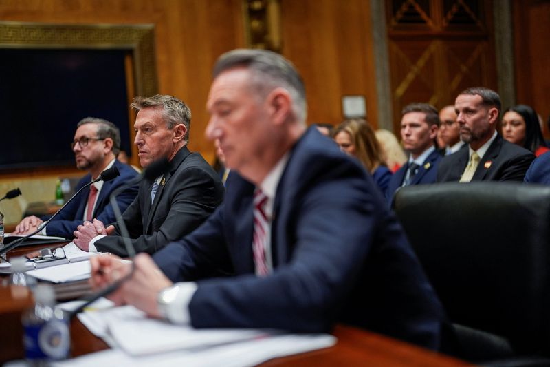 U.S. Customs and Border Protection (CBP) Commissioner Rodney Scott sits next to U.S. Citizenship and Immigration Services (USCIS) Director Joseph Edlow and U.S. Immigration and Customs Enforcement (ICE) Acting Director Todd Lyons as they attend a Senate Homeland Security and Government Affairs Committee hearing on Capitol Hill in Washington, D.C., U.S., February 12, 2026. REUTERS/Kent Nishimura